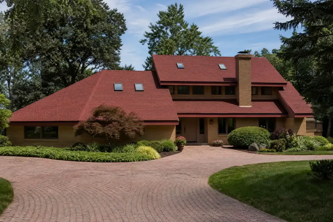 A beautiful white multi-level home gleams in the bright sunlight, showing off its crisp horizontal exterior panels upgraded by professional siding services.